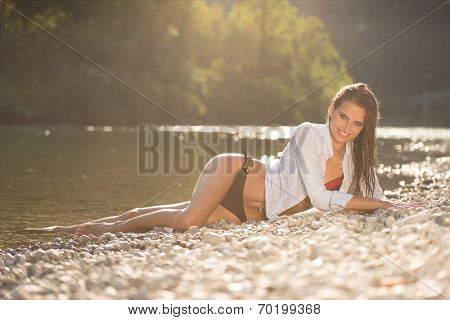 Preety Woman In Swimsuit Near Alpine River In Early Summer
