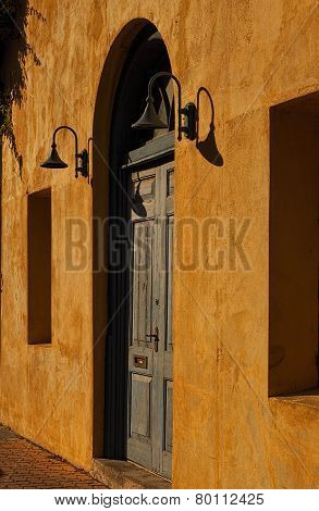 Weathered Blue Door In A Yellow Wall