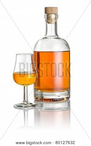 Bottle and snifter filled with amber liquid