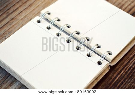 An empty retro spiral notebook with old paper