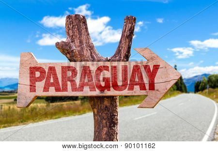 Paraguay wooden sign with road background