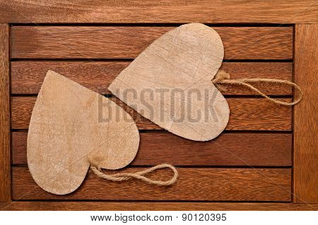 Two beart shapes on a wooden background