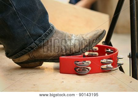 Musician Are Using A Foot Knocked Tambourine