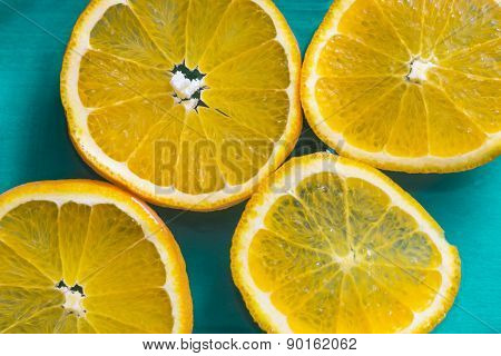 Bright Slices Of Juicy Oranges On Blue Background