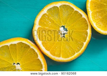 Bright Slices Of Juicy Oranges On Blue Background