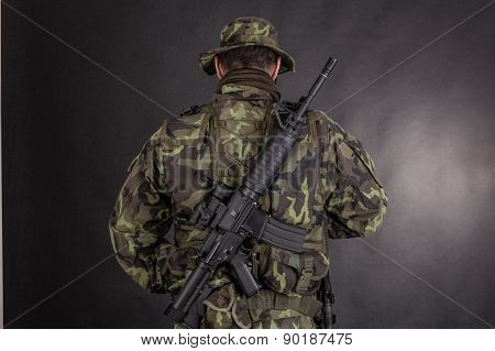 Soldier In Camouflage And Modern Weapon M4.