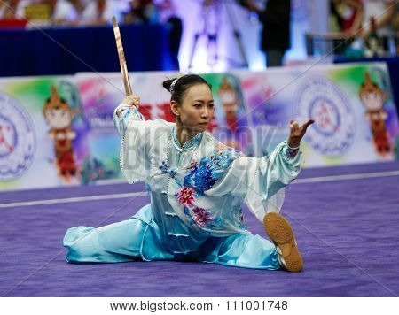 JAKARTA, INDONESIA - NOVEMBER 15, 2015: Shin Ng of Malaysia performs the movements in the women's Taijijian event at the 13th World Wushu Championship 2015 held at Istora Senayan, Jakarta.