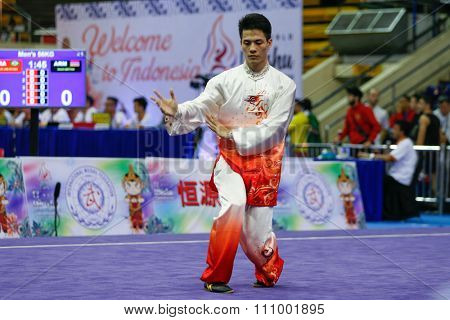 JAKARTA, INDONESIA - NOVEMBER 15, 2015: Zhou Li Chen of China performs the movements in the men's Taijiquan event at the 13th World Wushu Championship 2015 held in Istora Senayan, Jakarta.