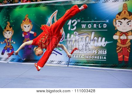 JAKARTA, INDONESIA - NOVEMBER 15, 2015: Daria Tarasova of Russia performs the movements in the women's Shuangjian event at the 13th World Wushu Championship 2015 held in Istora Senayan, Jakarta.