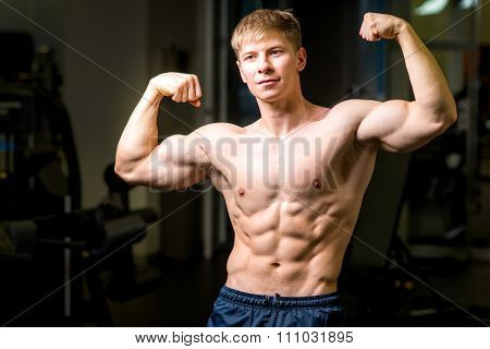 Handsome power athletic guy male. Fitness muscular body.