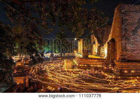 Ancient temple walking with lighted candles in hand around a temple candles light trail of Buddhism