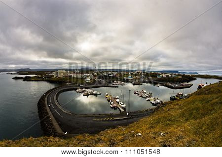 Stykkisholmur harbor in west Icelandic fjord with cityscape in background