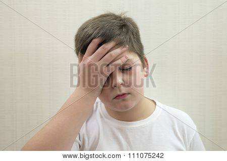 Portrait of  teenage boy with a headache