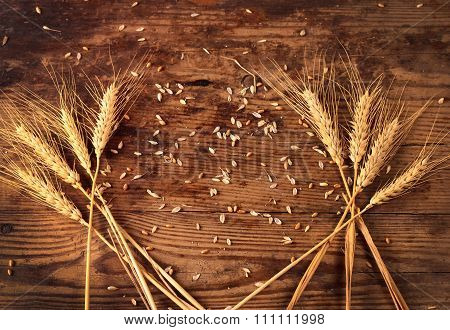 Ears Of Wheat On Wooden Background
