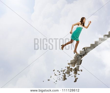 Young woman walking up collapsing staircase representing success concept