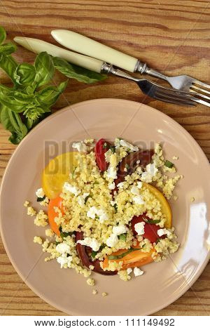 Millet with basil and fresh tomatoes and goat cheese