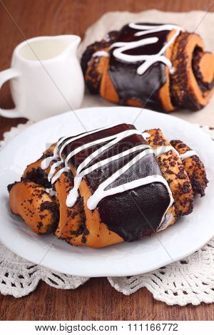 Rolls Of Dough Biscuit With Poppy Seeds And Chocolate Icing