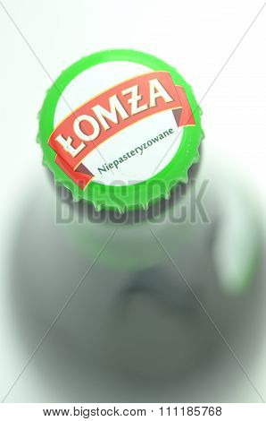 Lomza unpasteurized lager beer isolated on white background