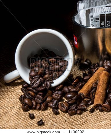 Coffee beans, cinnamon and cup