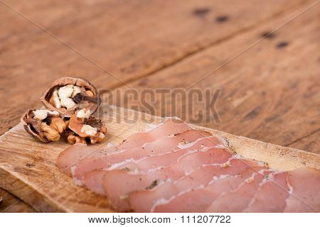 dried pork tenderloin on a rough wooden rustic table