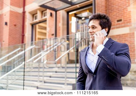 Portrait of confident businessman with his mobile phone outdoors