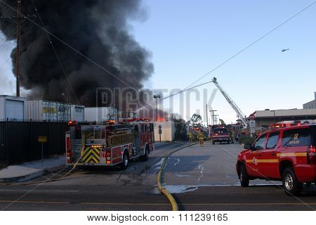 HARBOR GATEWAY, CALIFORNIA- DECEMBER 12, 2015: Fire erupts at recycling yard in Harbor Gateway. Dozens of Fire Trucks arrive to help extinguish an industrial fire, California Dec. 12, 2015 
