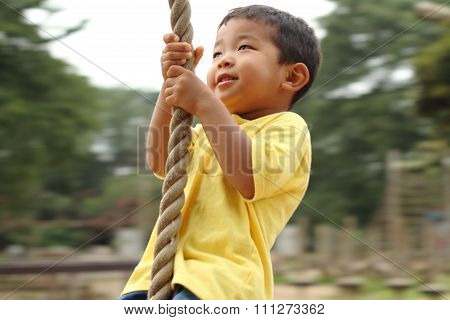 Japanese boy playing with Tarzan rope (3 years old)