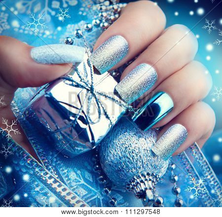 Christmas Nail art manicure. Winter Holiday style bright Manicure Design. Christmas decorations and snowflakes. Nail Polish. Beauty hands. Trendy Stylish Silver and Blue Colorful Nails, Nailpolish
