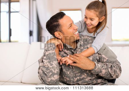 pretty little girl hugging her military father