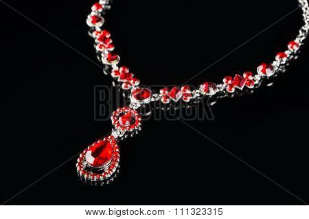 Vintage pendant with ruby and crystals on   black background