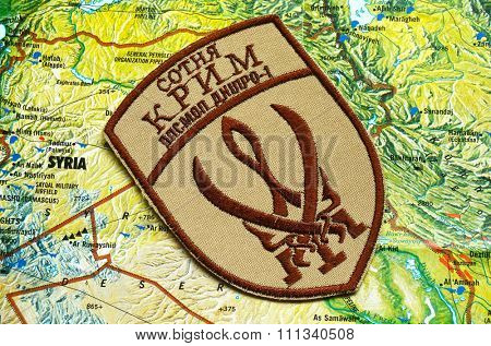 Kiev, Ukraine.NOV 13.Illustrative editorial. Chevron of Islamic extremist formation Crimea as part of Ukrainian Army.Background map November 13, 2015 in Kiev, Ukraine