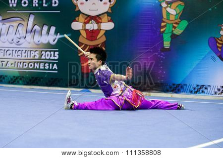 JAKARTA, INDONESIA - NOVEMBER 17, 2015: Wong Weng Son of Malaysia performs the movements in the men's Qiangshu event at the 13th World Wushu Championship 2015 at the Istora Senayan Stadium.