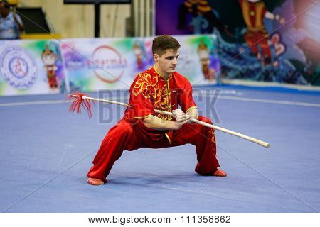 JAKARTA, INDONESIA - NOVEMBER 17, 2015: Andrei Solovev of Russia performs the movements in the men's Qiangshu event at the 13th World Wushu Championship 2015 at the Istora Senayan Stadium.