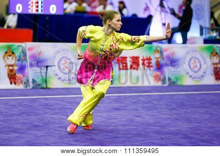 JAKARTA, INDONESIA - NOVEMBER 17, 2015: Liudmyla Temna of Ukraine performs the movements in the women's Compulsory Changquan event at the 13th World Wushu Championship 2015 in Istora Senayan Stadium.