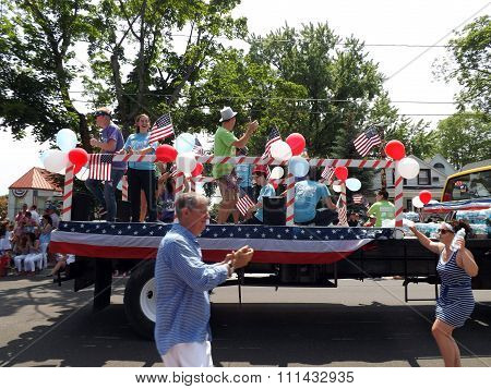 Young Americans Riding a Truck in the 4th of July Parade