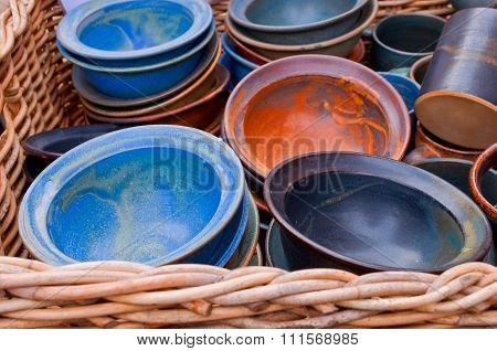 Ceramic Bowls In A Basket On A Market