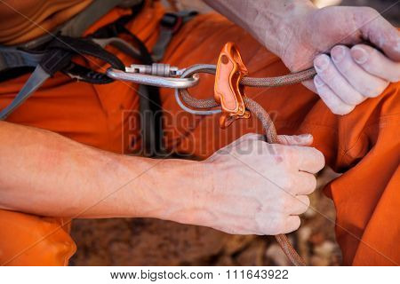 Rock climber holding belay rope - hands closeup