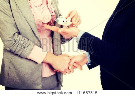 Caucasian businesswoman giving a plane to her partner.