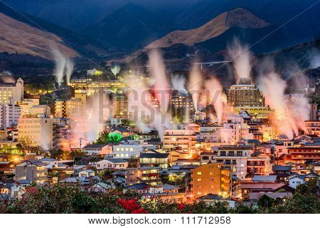 Beppu, Japan cityscape with hot spring bath houses and rising steam.