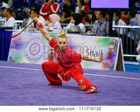 JAKARTA, INDONESIA - NOVEMBER 17, 2015: Marina Faure of France performs the movements in the women's Jianshu event at the 13th World Wushu Championship 2015 in Istora Senayan Stadium.