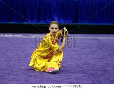 JAKARTA, INDONESIA - NOVEMBER 17, 2015:Liudmyla Temna of Ukraine performs the movements in the women's Jianshu event at the 13th World Wushu Championship 2015 in Istora Senayan Stadium.