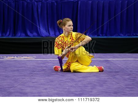 JAKARTA, INDONESIA - NOVEMBER 17, 2015:Liudmyla Temna of Ukraine performs the movements in the women's Jianshu event at the 13th World Wushu Championship 2015 in Istora Senayan Stadium.