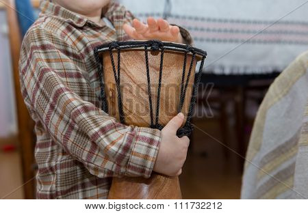 Small Child Playing On Drum