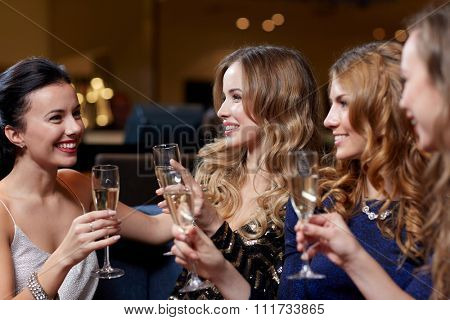 celebration, friends, bachelorette party and holidays concept - happy women with champagne glasses at night club