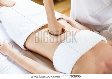Woman having abdomen massage.