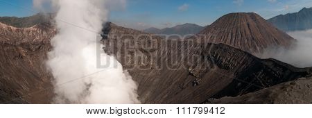 Volcano Bromo Errupting Smoke and sulphur under blue sky