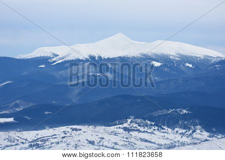 Winter landscape a cloudy day. Mountain peak in snow. View of Mount Hoverla, Carpathian Mountains, Ukraine