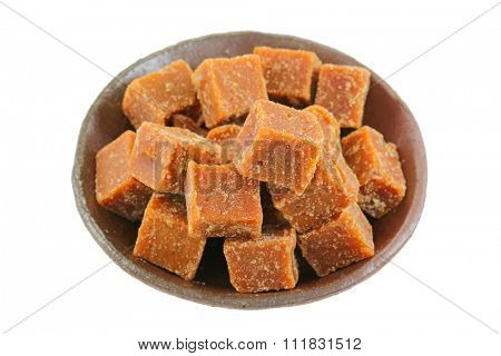 A bowl full of blocks of dark brown sugar made of cane sugar (jaggery), by evaporation of the sap of sugar cane juice