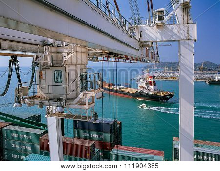 Crane moving containers in ports shipyard