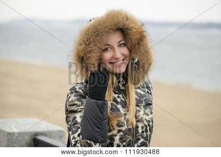 Portrait close up of young beautiful woman, on winter park nature background